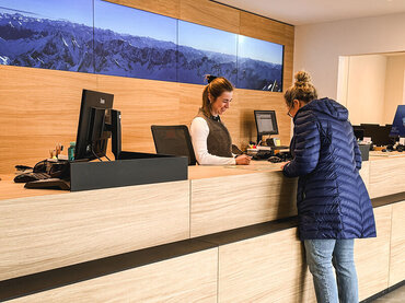 Blick auf eine Gästeberatung am Schalter in der Tourist Information | © GaPa Tourismus GmbH