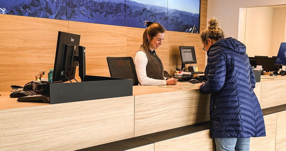 Blick auf eine Gästeberatung am Schalter in der Tourist Information | © GaPa Tourismus GmbH